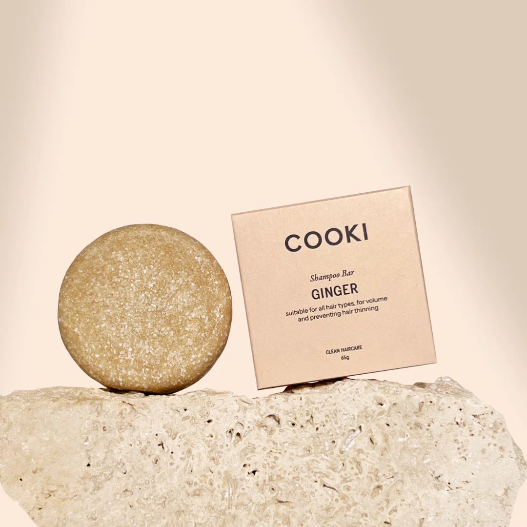 Cooki Ginger shampoo bar on a stone surface with a beige background