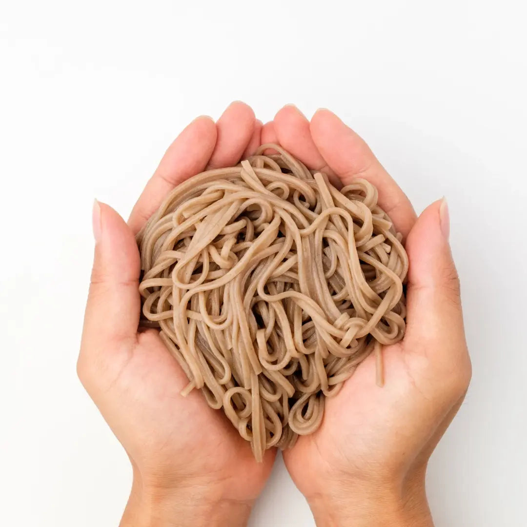 pile of king soba organic buckwheat noodles in hands