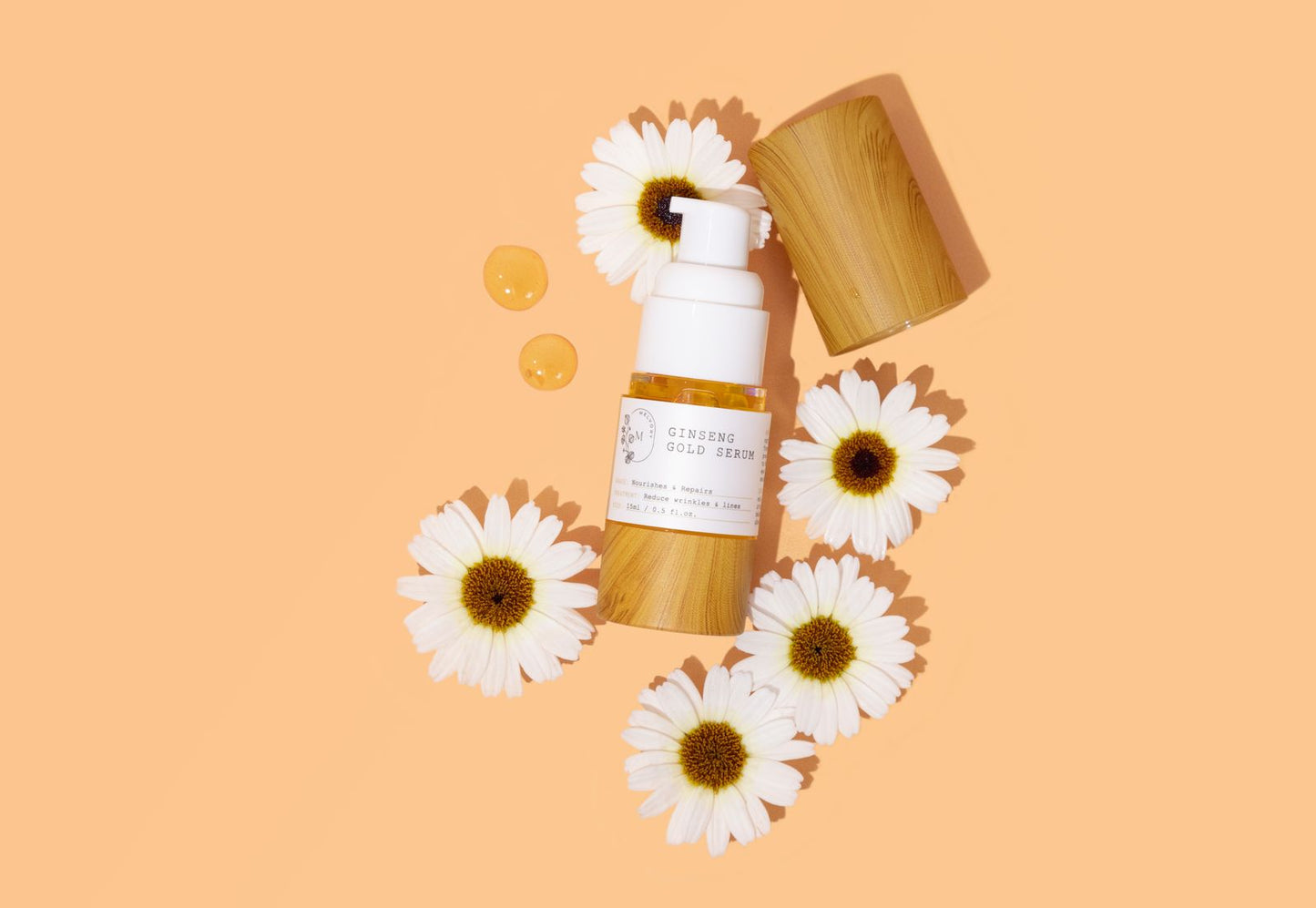 melvory ginseng gold serum and white flowers on a peach background