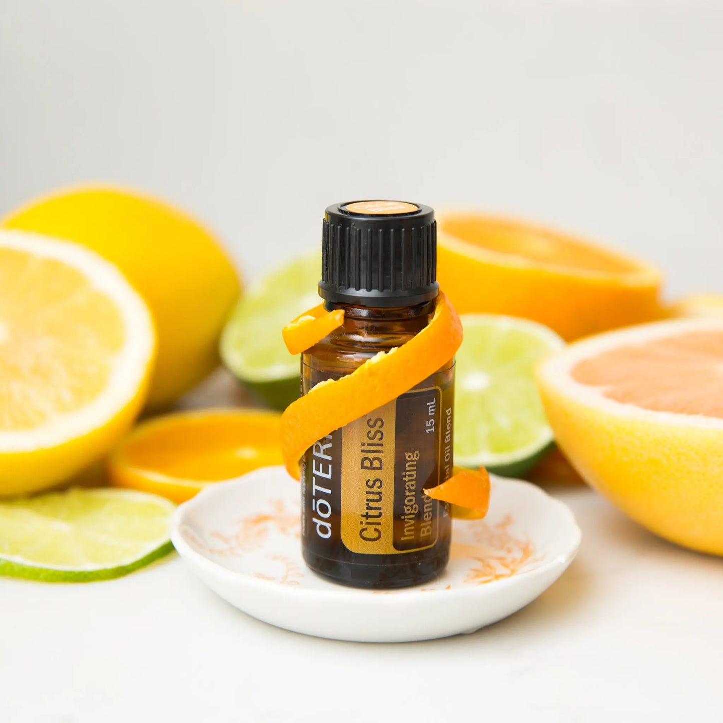 bottle ogdoterra cirus bliss essential oil styled with citrus fruits