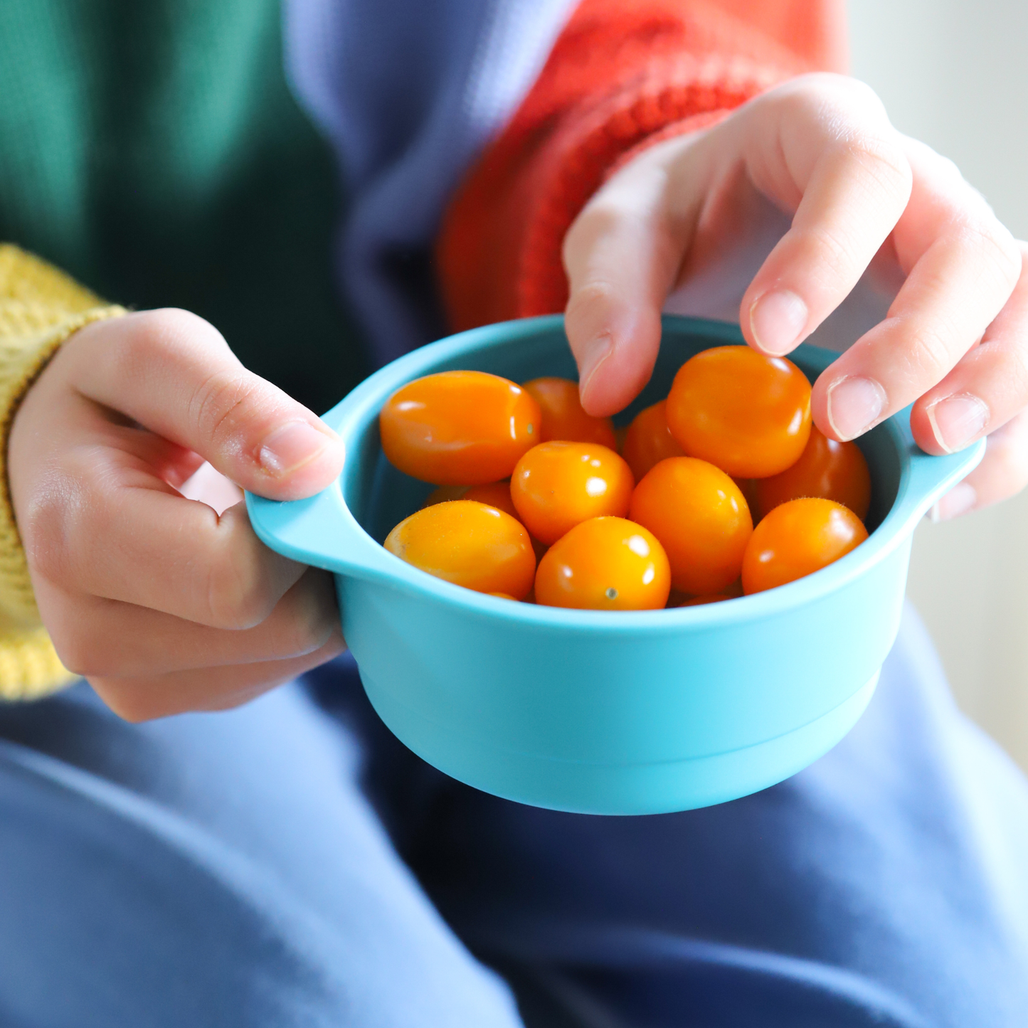 snack bowl blue with cherry tomatoes being eaten by child, bobo and boo