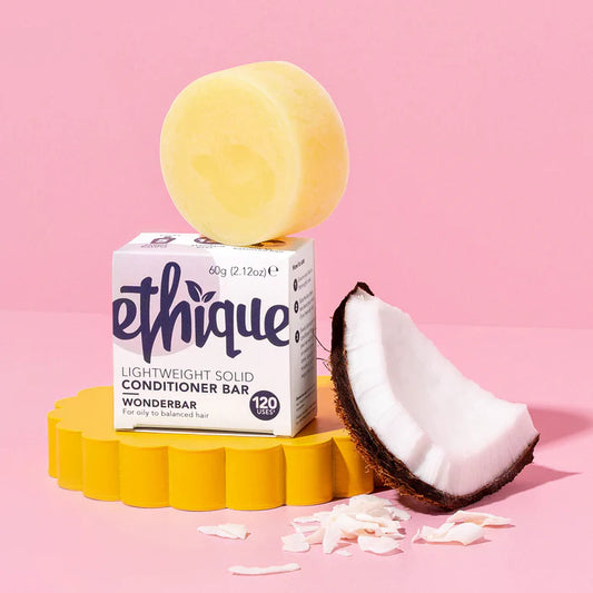 Ethique conditioner bar with packaging on a pink background
