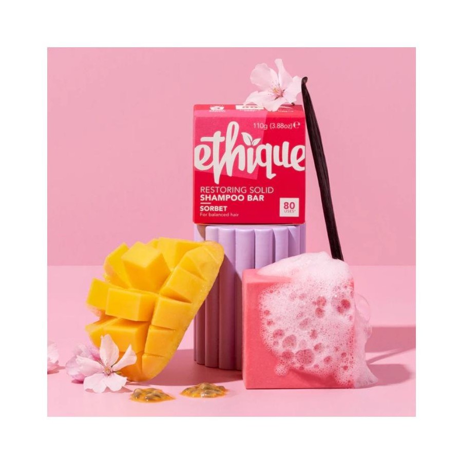 ethique sorbet shampoo bar and packaging with a mango and pink soap bar on a pink background