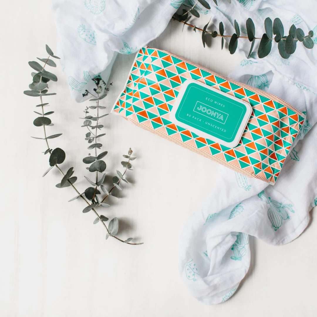 Joonya eco wipes packaging with geometric design on a white background with eucalyptus leaves.