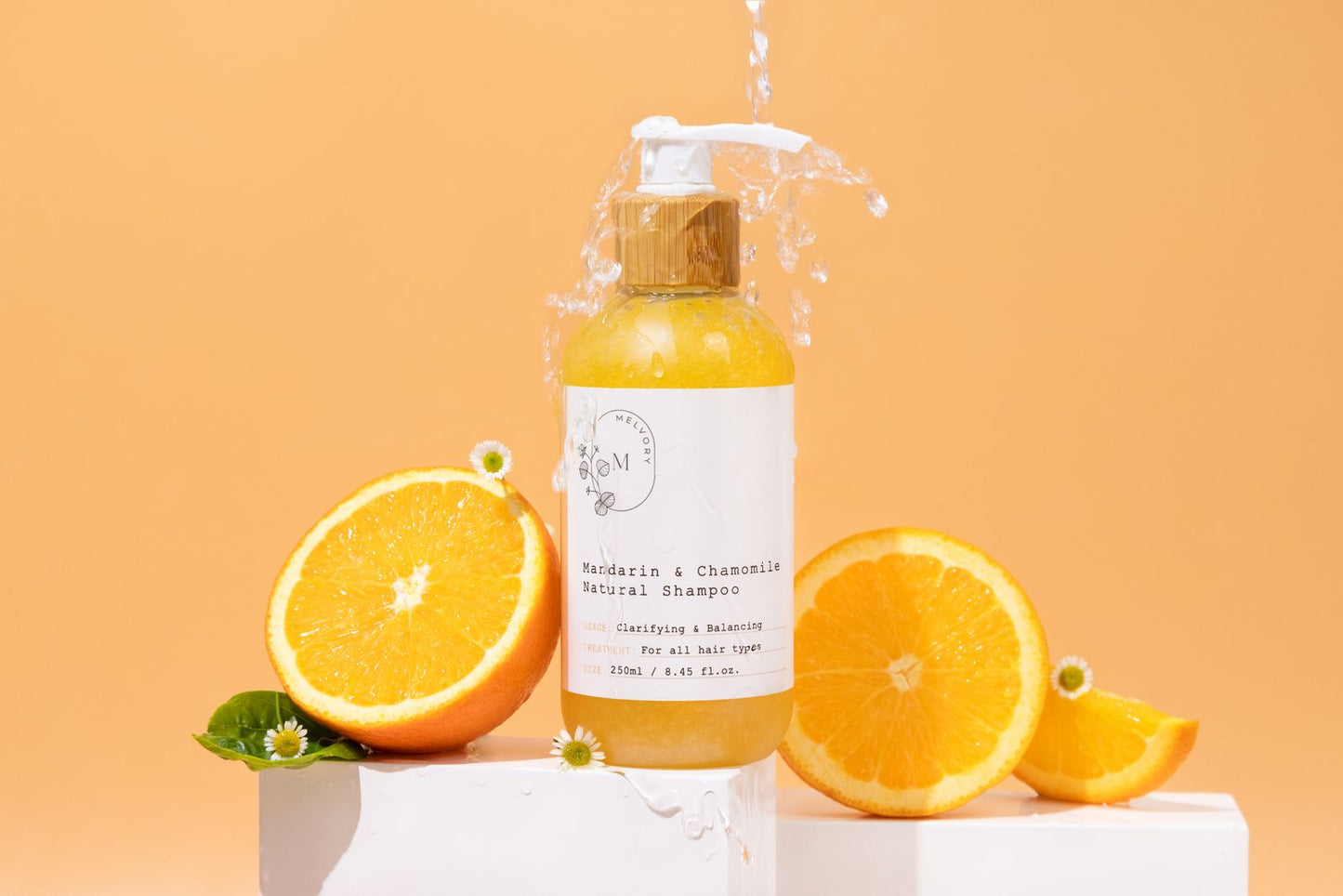 Melvory skincare Shampoo bottle with pump and oranges on a peach background