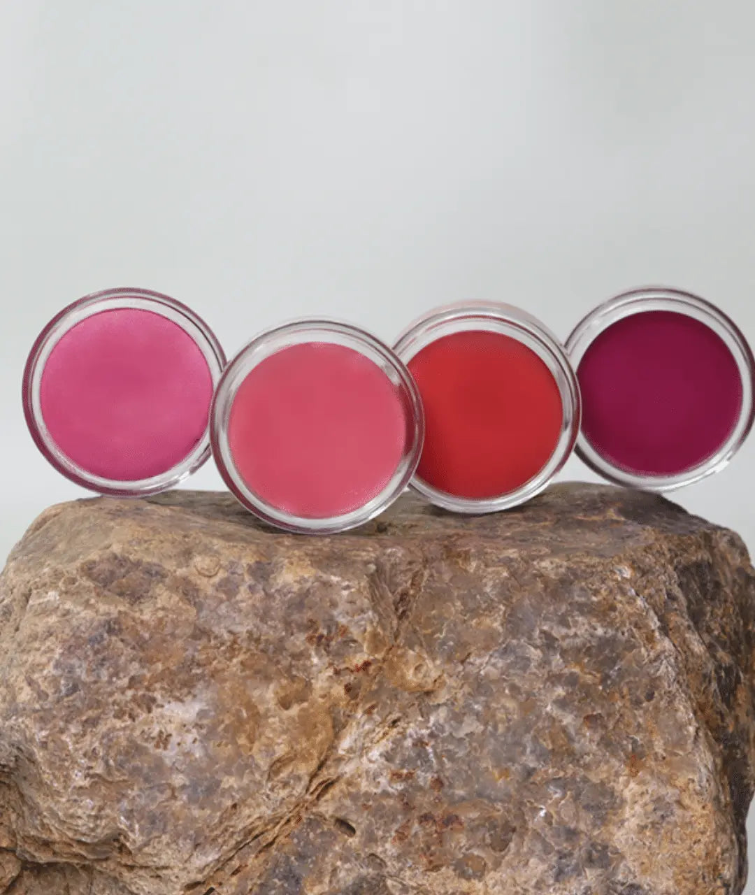 MG Naturals Lip and Cheek Tint colour range displayed on a rock