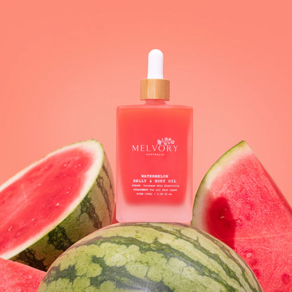 Melvory watermelon belly & body oil bottle with watermelons on a pink background