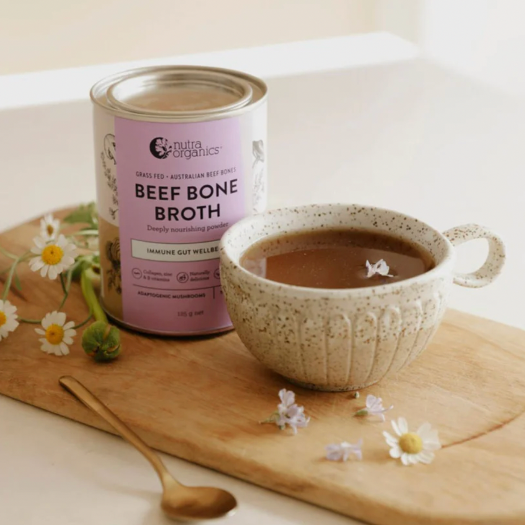 nutra organics mushroom beef bone broth tin with a cup of nourishing broth