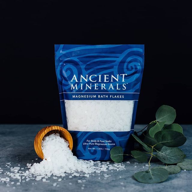 ancient minerals magnesium bath flakes bag with bowl of flakes and greenary