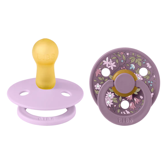 bibs x liberty baby pacifiers with floral design on a white background