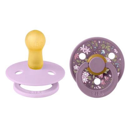 bibs x liberty baby pacifiers with floral design on a white background