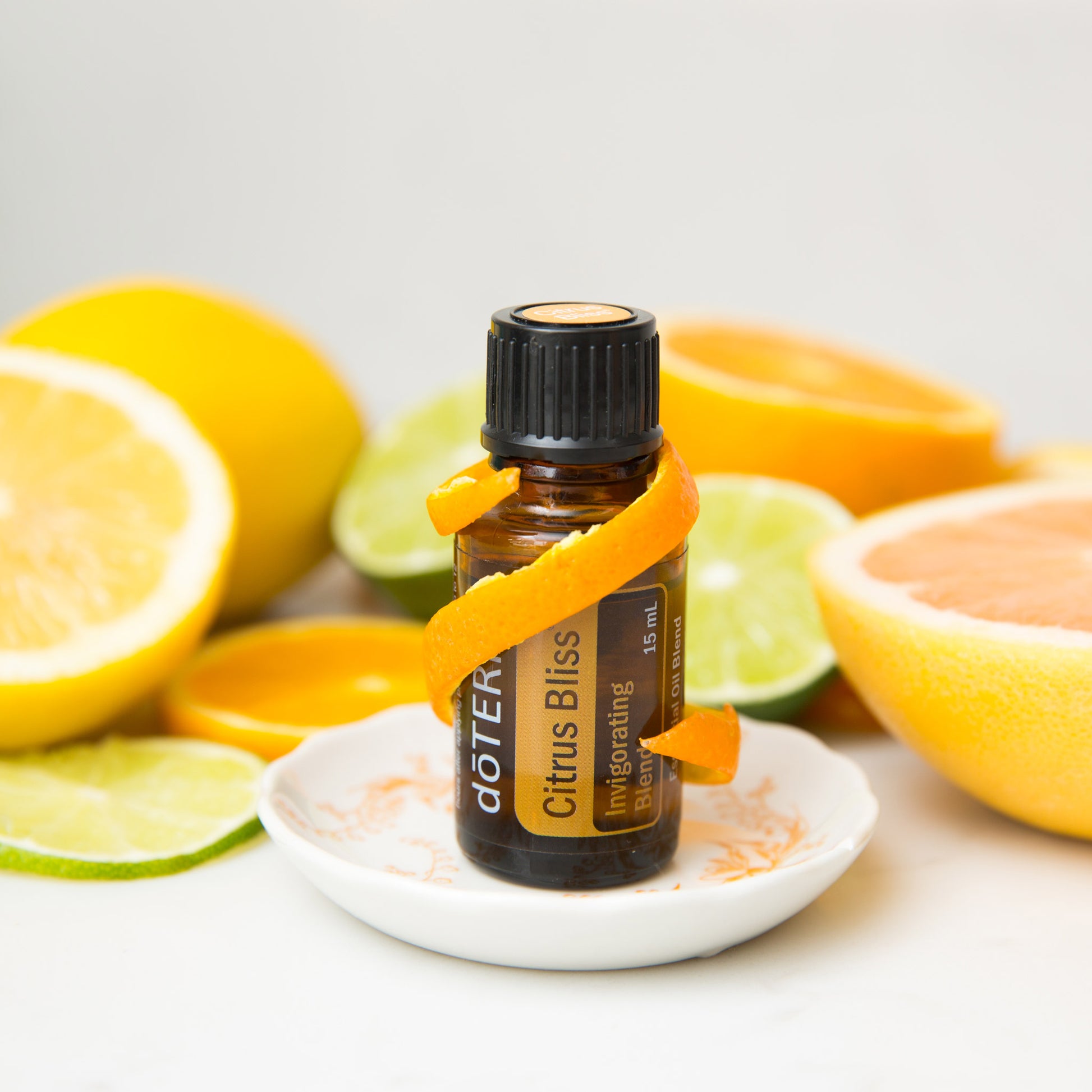 bottle ogdoterra cirus bliss essential oil styled with citrus fruits