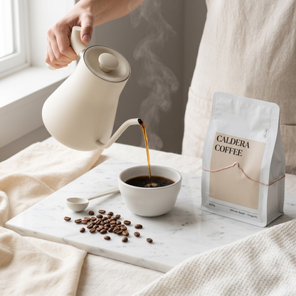 caldera coffee 250g whole bean bag beside a cup of coffee being poured