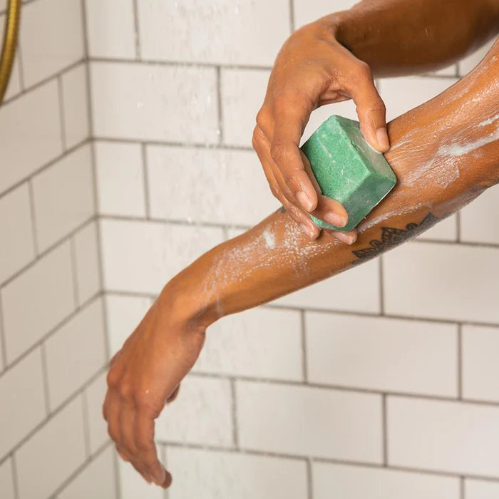 ethique lime and ginger body polish bar in use
