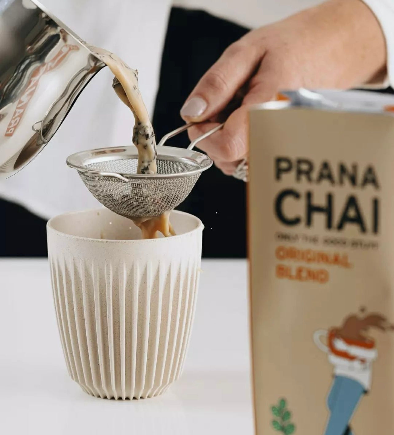 prana chai original blend being poured into mug