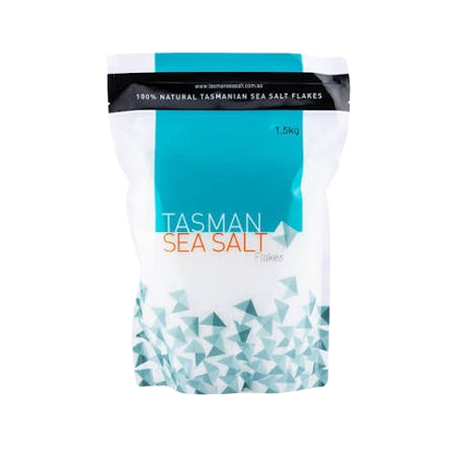 A 1.5kg bag of Tasman Sea Salt Flakes, featuring a white and teal design with a geometric pattern at the bottom, on a plain white background.