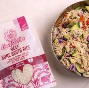 Bag of love my earth Beef Bone Broth Rice and a bowl of rice salad on a white background