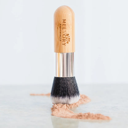 melvory Makeup brush with wooden handle and silver ferrule on a light gray background