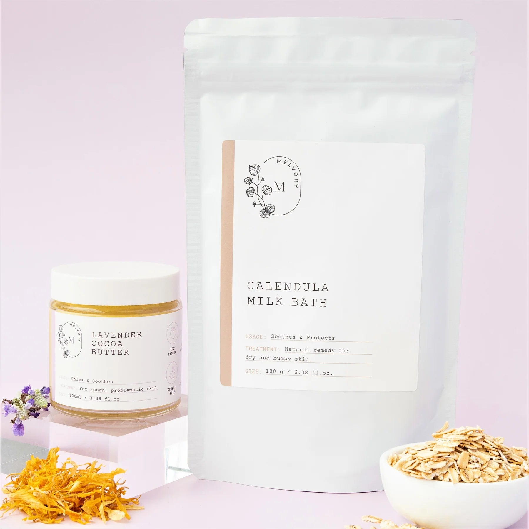 Melvory Calendula milk bath package with a jar of lavender cocoa butter product on a light purple background.