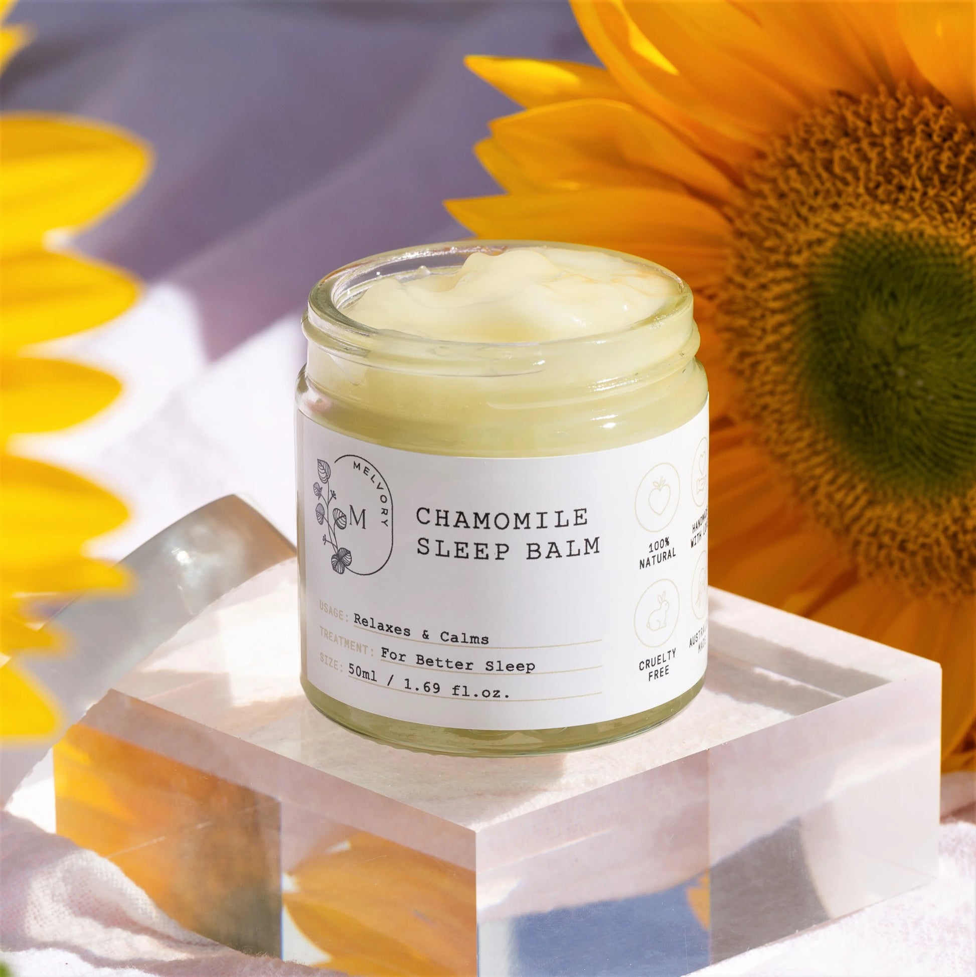 melvory chamomile sleep balm jar with sunflower in the background