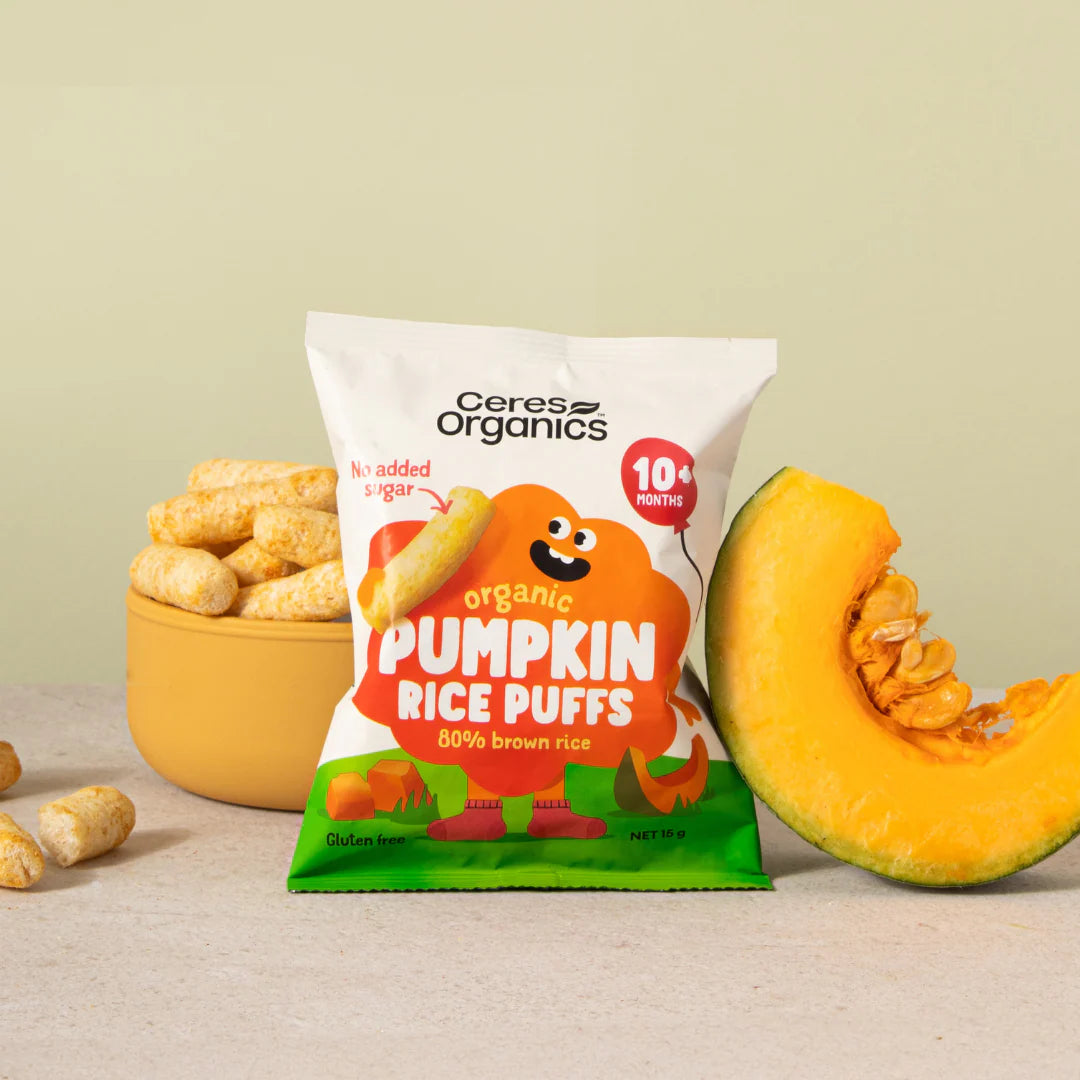 Ceres Organics pumpkin rice puffs package with a pumpkin and bowl of puffs on a beige background